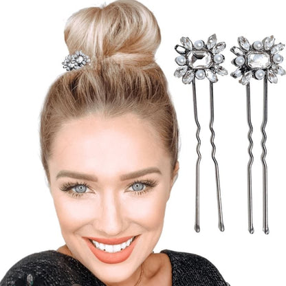 Two u-shaped hair pins with a large rectangular clear rhinestone in the center, surrounded by a cluster of small pearls and rhinestones. 