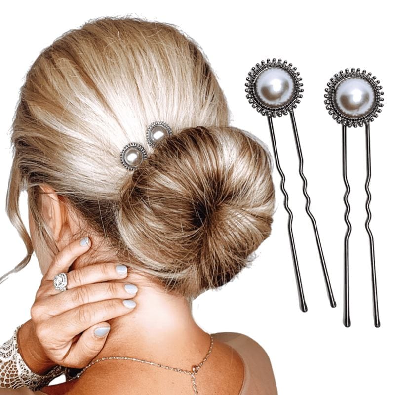 Two u-shaped hair pins with an antique pearl in the center, surrounded by small metal circle.